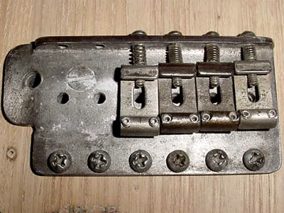 Slotted screws holding trem block
